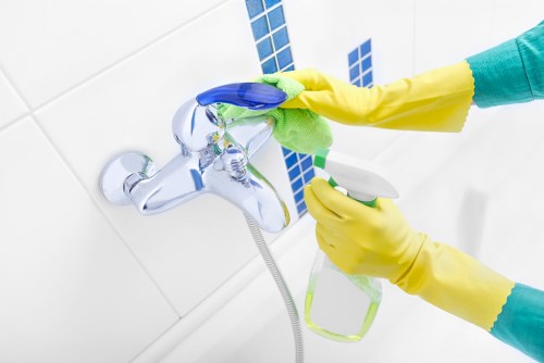 Cleaner using protective gloves and equipment during carpet cleaning